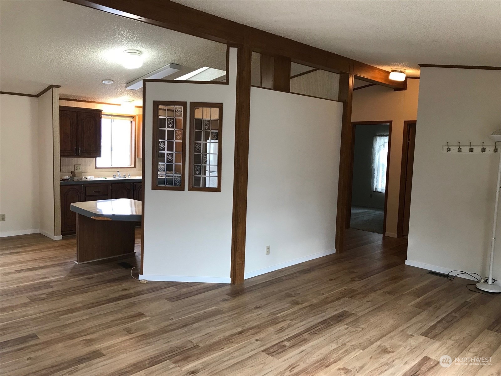 600 Northeast Lincoln Road, Unit 30 Poulsbo, WA 98370 - Photo 11 of 14 a view of a hallway with wooden floor and a refrigerator