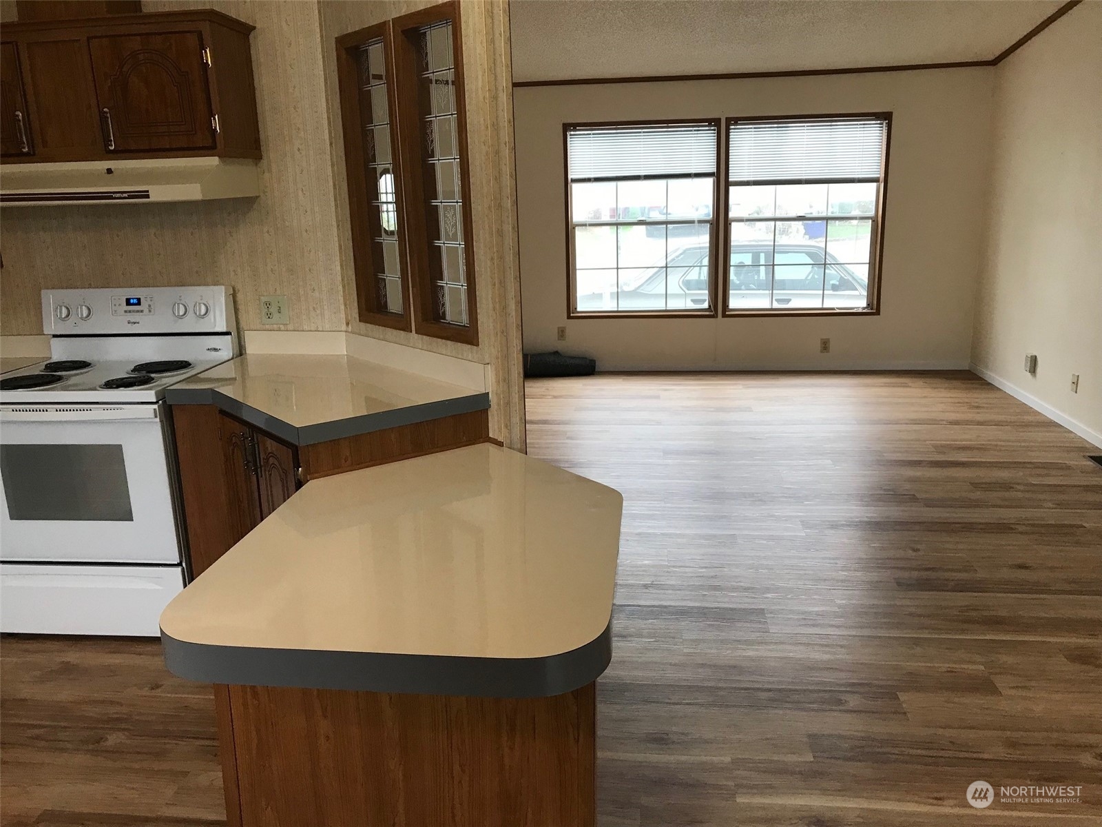 600 Northeast Lincoln Road, Unit 30 Poulsbo, WA 98370 - Photo 9 of 14 a kitchen with a wooden floor and a refrigerator