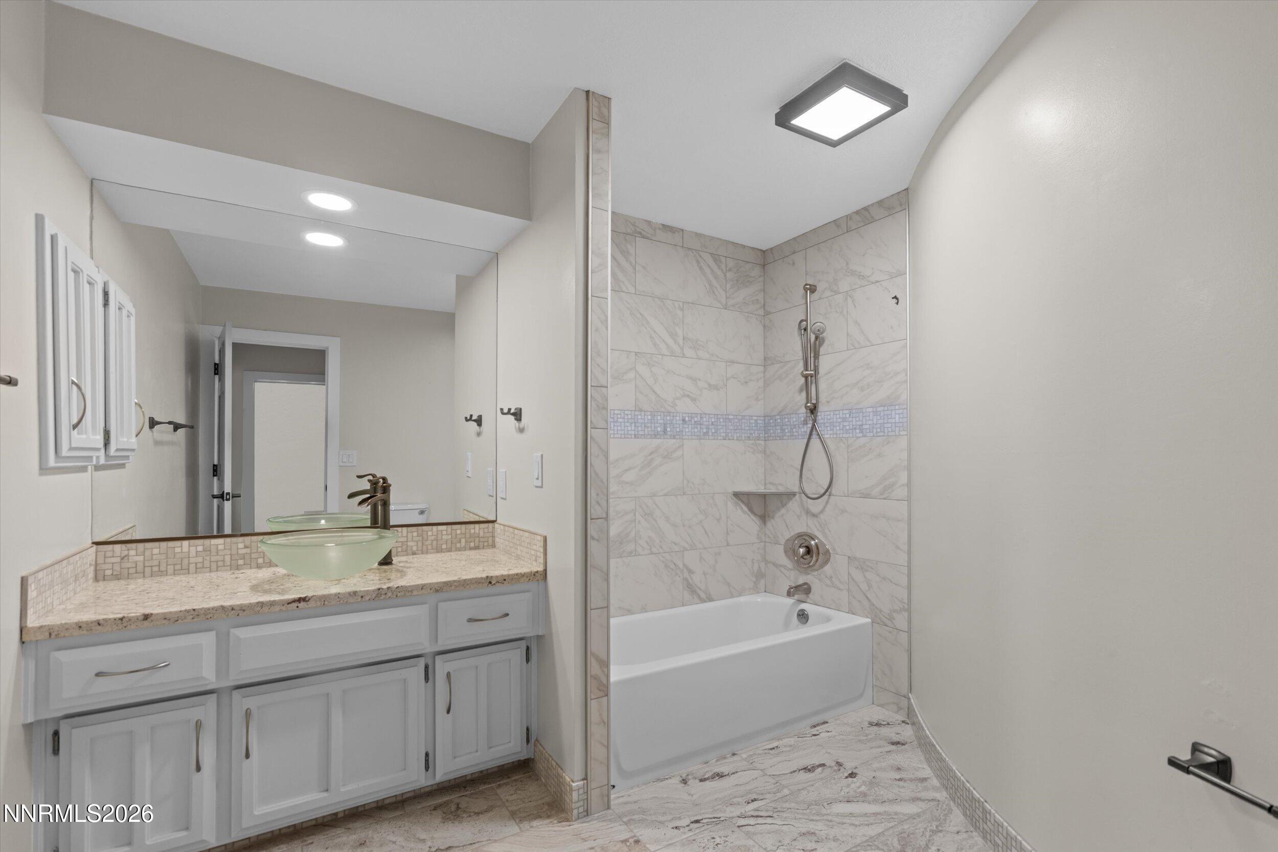 2725 West Lake Ridge Shores Reno, NV 89519 - Photo 37 of 49 a bathroom with a tub a sink and a mirror