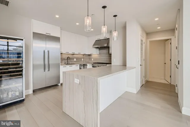 a kitchen with cabinets and stainless steel appliances