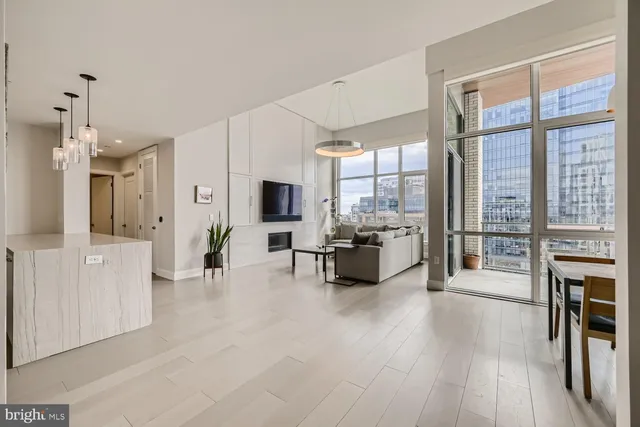 a view of a living room kitchen and a large window