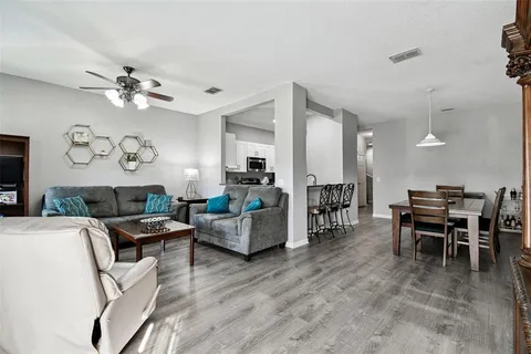 a living room with furniture a dining table and a fireplace