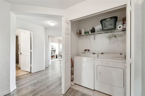 a view of washer and dryer with kitchen in the background