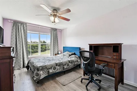 a bedroom with a bed a desk and chair