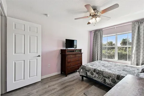 a bedroom with a large bed and a tv