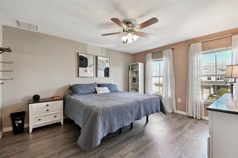 a bedroom with a large bed and a chandelier