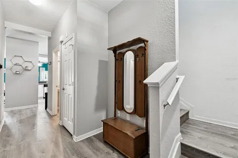 a view of entryway and hall with wooden floor