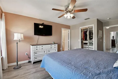 a bedroom with a bed and a flat screen tv