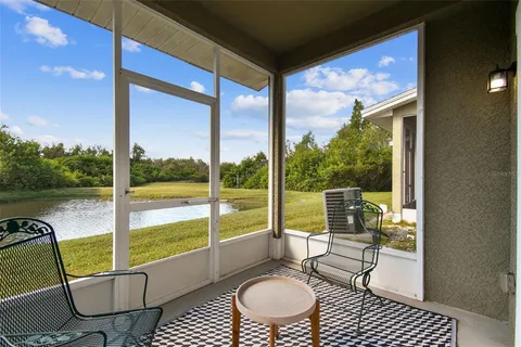 a living room with a floor to ceiling window and a table