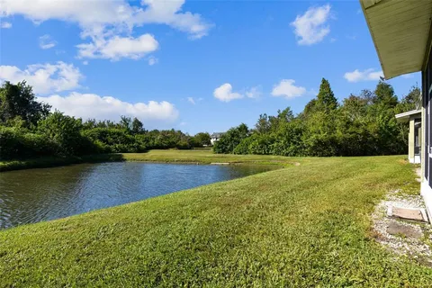 a view of a lake with houses in the back