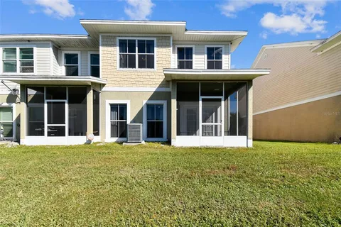 a view of brick building with a yard