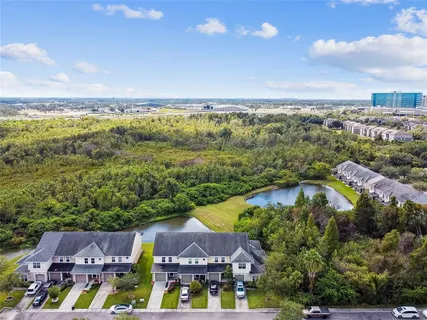 an aerial view of residential houses with outdoor space and swimming pool