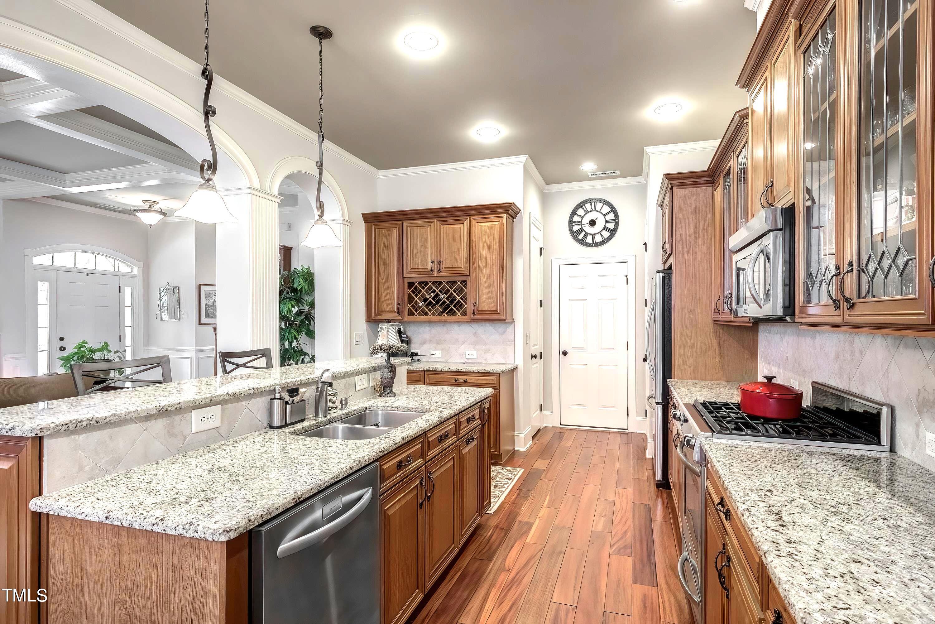 133 Sunstone Drive Cary, NC 27519 - Photo 12 of 37 a kitchen with stainless steel appliances granite countertop a sink stove and refrigerator