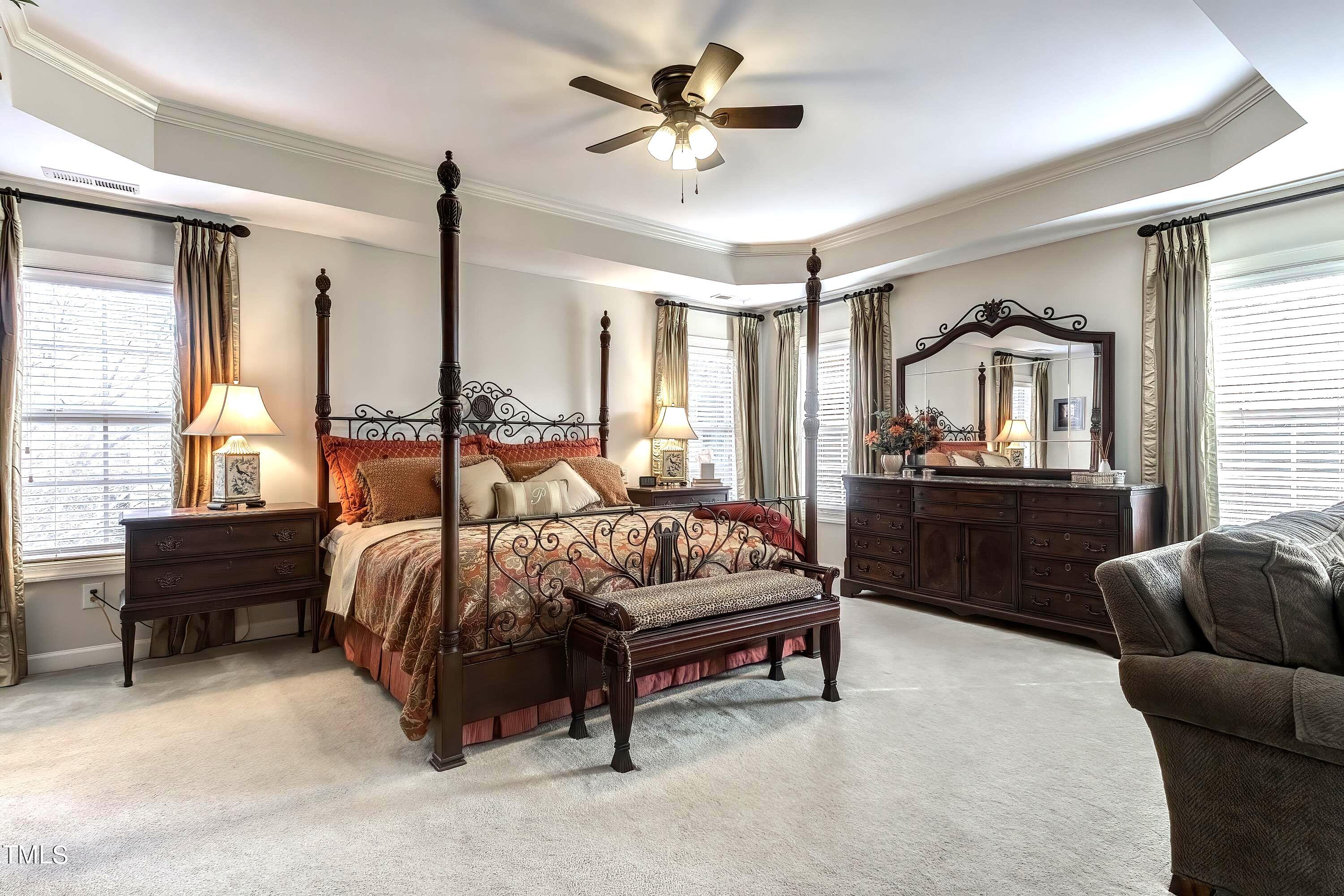 133 Sunstone Drive Cary, NC 27519 - Photo 20 of 37 a spacious bedroom with a bed and a chandelier