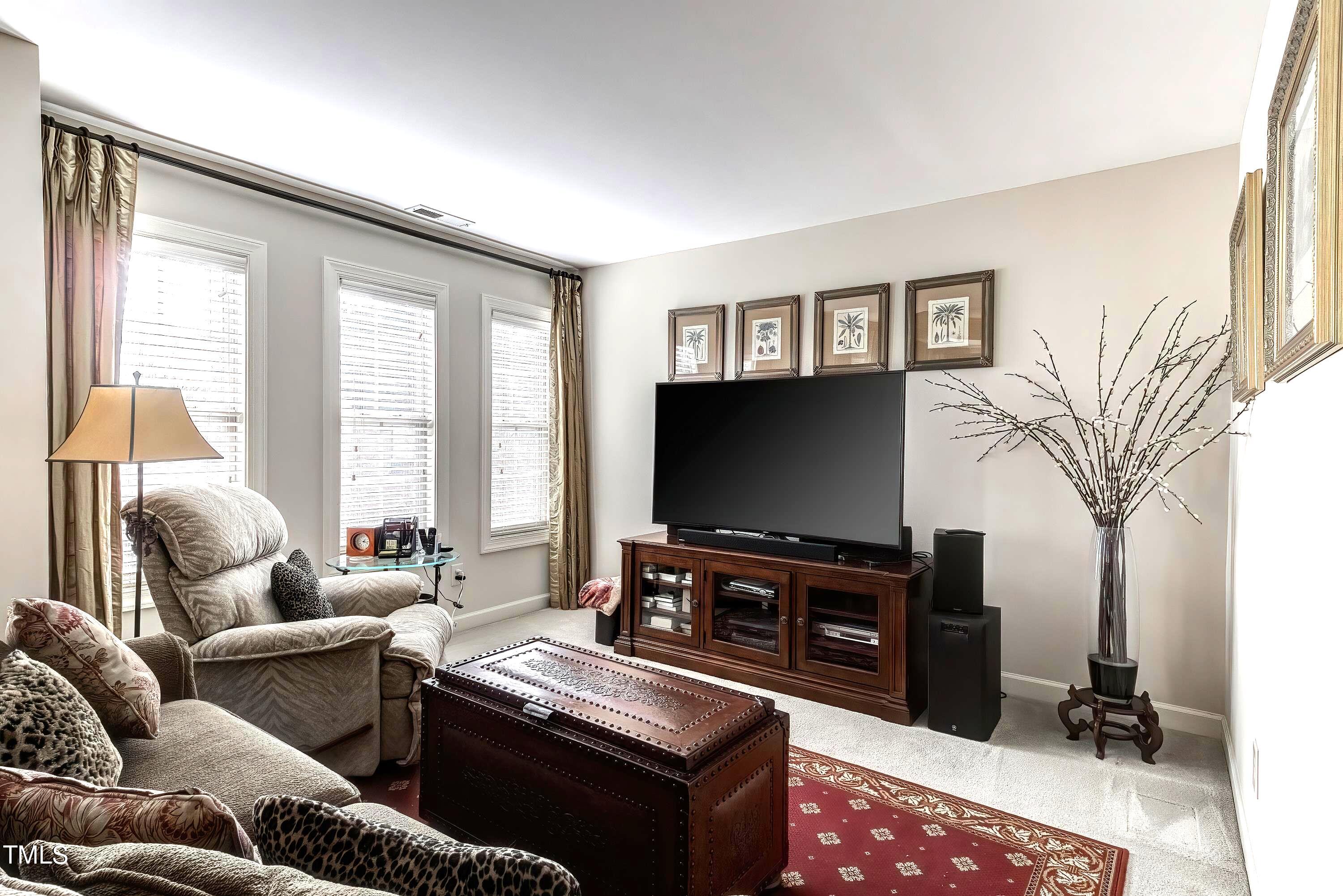 133 Sunstone Drive Cary, NC 27519 - Photo 22 of 37 a living room with furniture and a flat screen tv