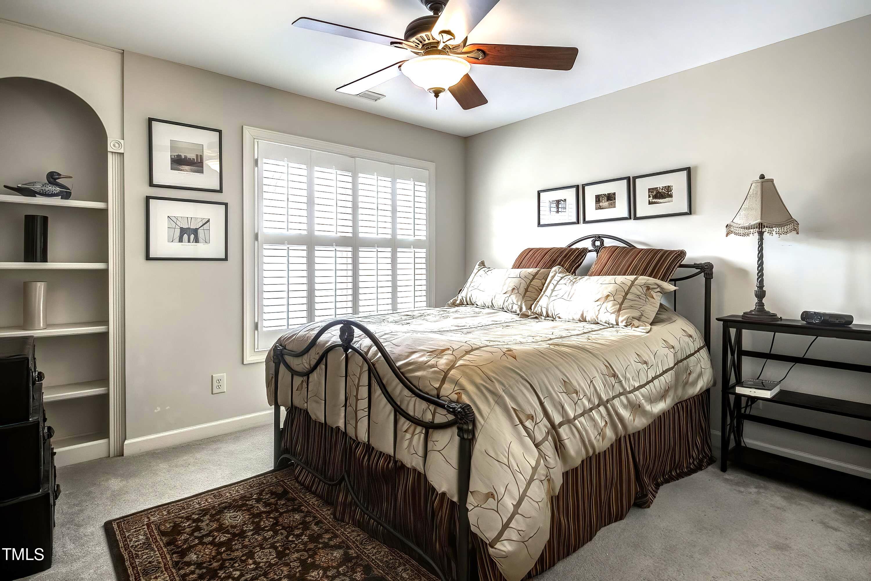 133 Sunstone Drive Cary, NC 27519 - Photo 25 of 37 a bedroom with a bed and a chandelier