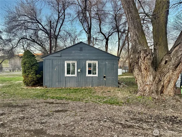 a house that has a tree in front of it