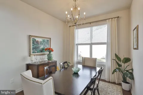 a living room with furniture a large window and a fireplace