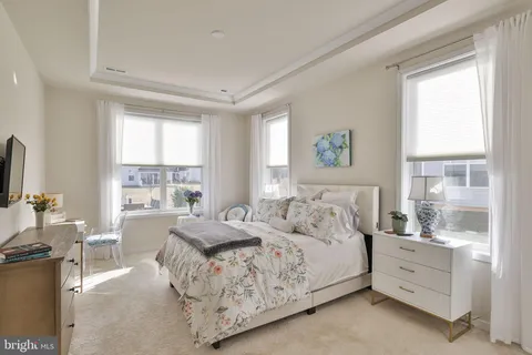 a living room with furniture kitchen view and a wooden floor