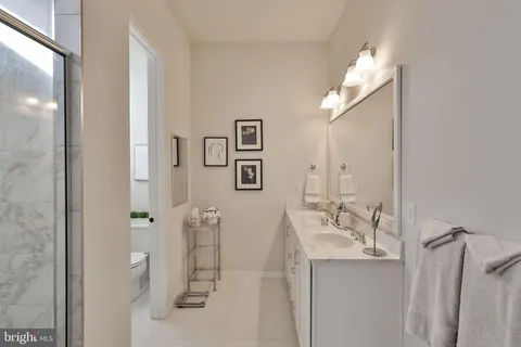 a kitchen with stainless steel appliances granite countertop a sink refrigerator and cabinets