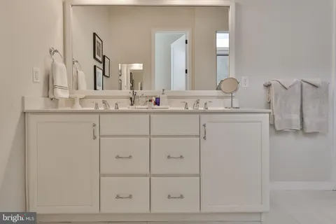 a kitchen with stainless steel appliances granite countertop a sink dishwasher a refrigerator and a stove with wooden floor