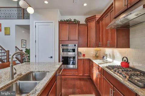 a view of a patio with couches and table and chairs and potted plants