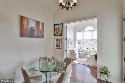 a living room with furniture a wooden floor and next to a window
