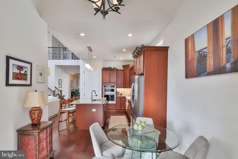 a living room with lots of furniture a rug potted plant and a large window