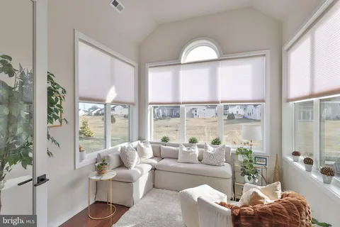 a living room with furniture and a floor to ceiling window