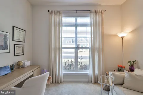 a view of a livingroom with furniture wooden floor and a chandelier