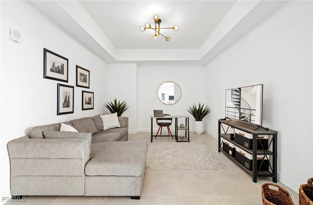 1125 Central Avenue, Unit 463 Naples, FL 34102 - Photo 11 of 42 a living room with furniture a table and a potted plant