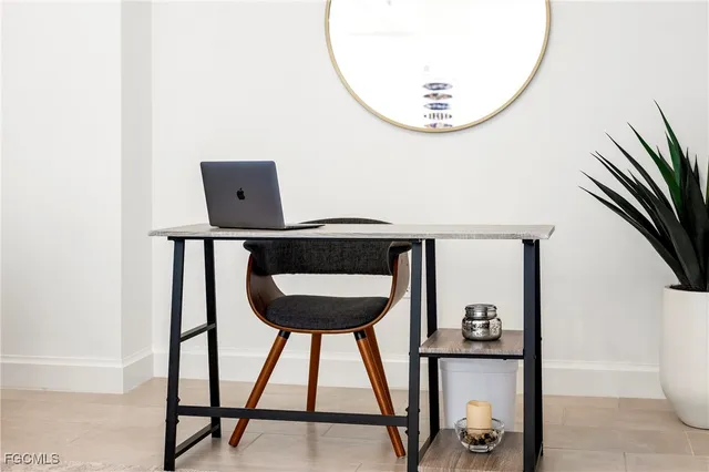 a front view of a room with a mirror and wooden floor