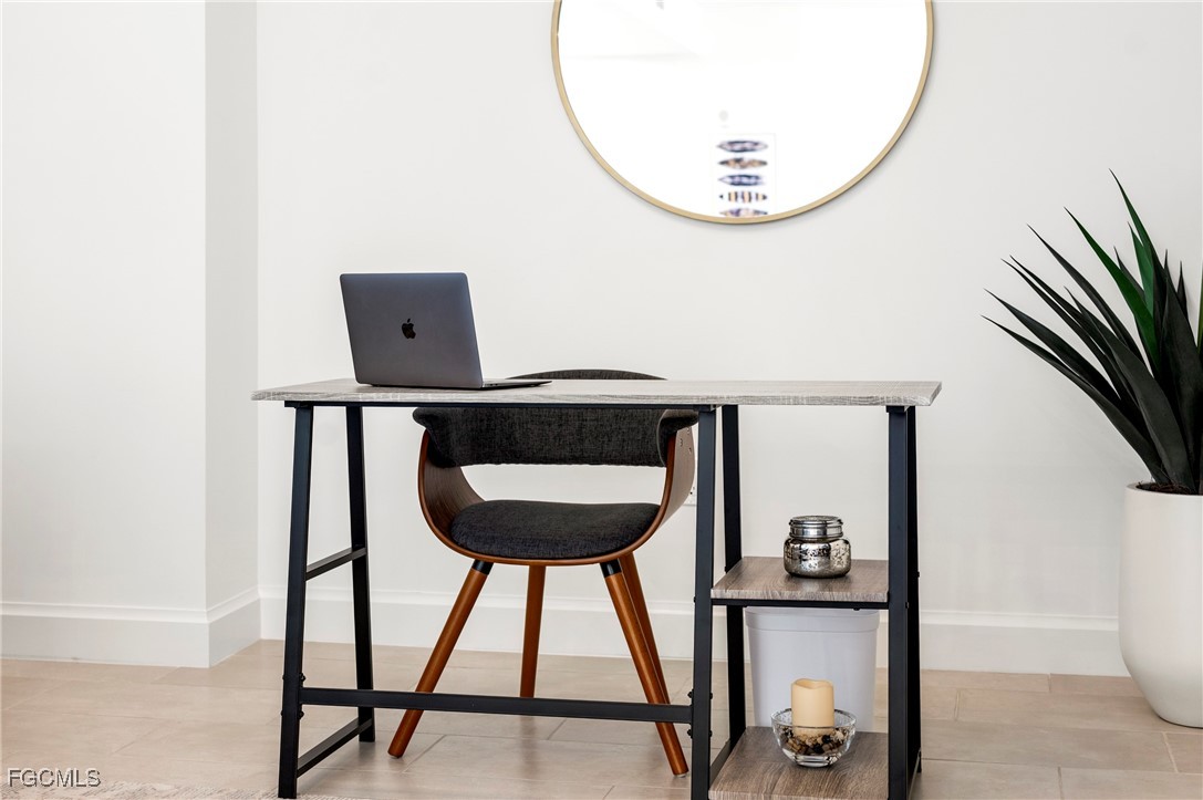 1125 Central Avenue, Unit 463 Naples, FL 34102 - Photo 12 of 42 a front view of a room with a mirror and wooden floor