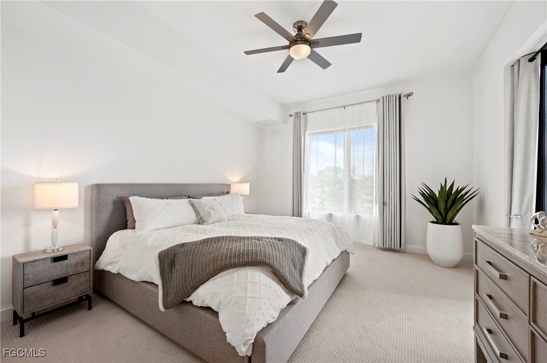 1125 Central Avenue, Unit 463 Naples, FL 34102 - Photo 13 of 42 a spacious bedroom with a large bed and a potted plant