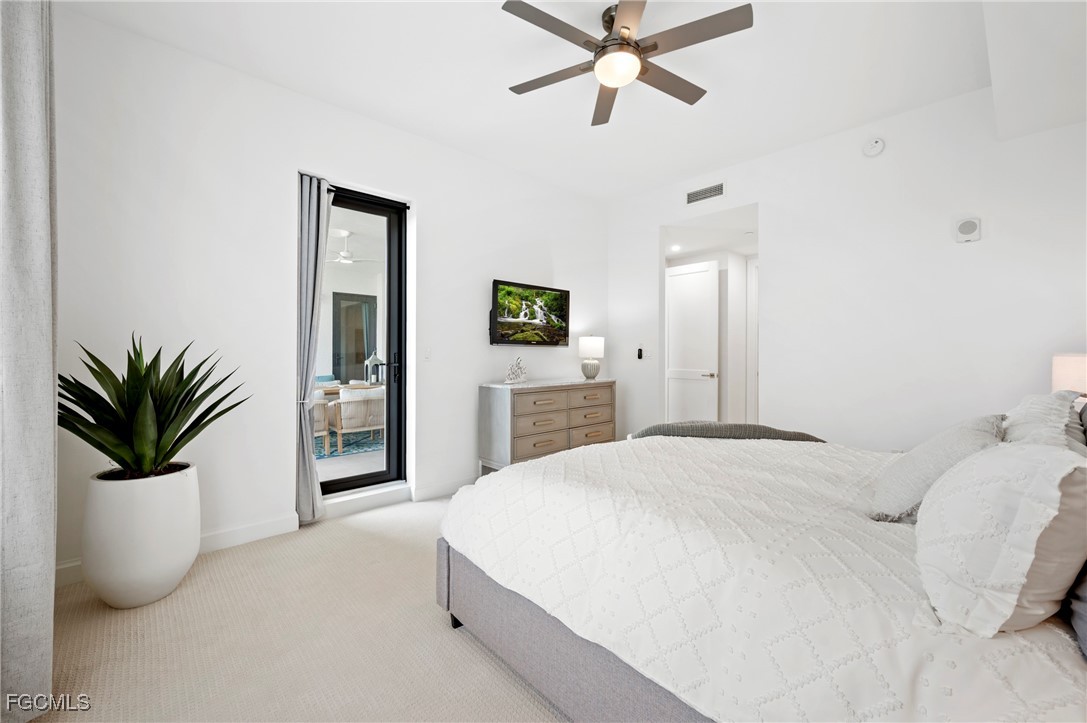 1125 Central Avenue, Unit 463 Naples, FL 34102 - Photo 14 of 42 a bedroom with a large bed and potted plant