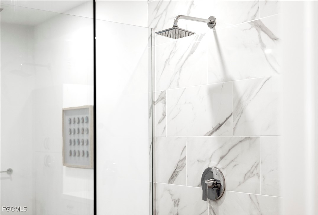 1125 Central Avenue, Unit 463 Naples, FL 34102 - Photo 24 of 42 a bathroom with a shower