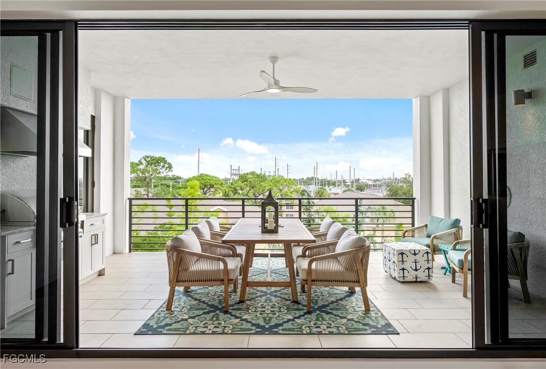 1125 Central Avenue, Unit 463 Naples, FL 34102 - Photo 25 of 42 a dining room with furniture and a floor to ceiling window