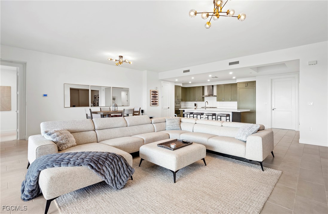 1125 Central Avenue, Unit 463 Naples, FL 34102 - Photo 4 of 42 a living room with furniture white walls and a view of kitchen