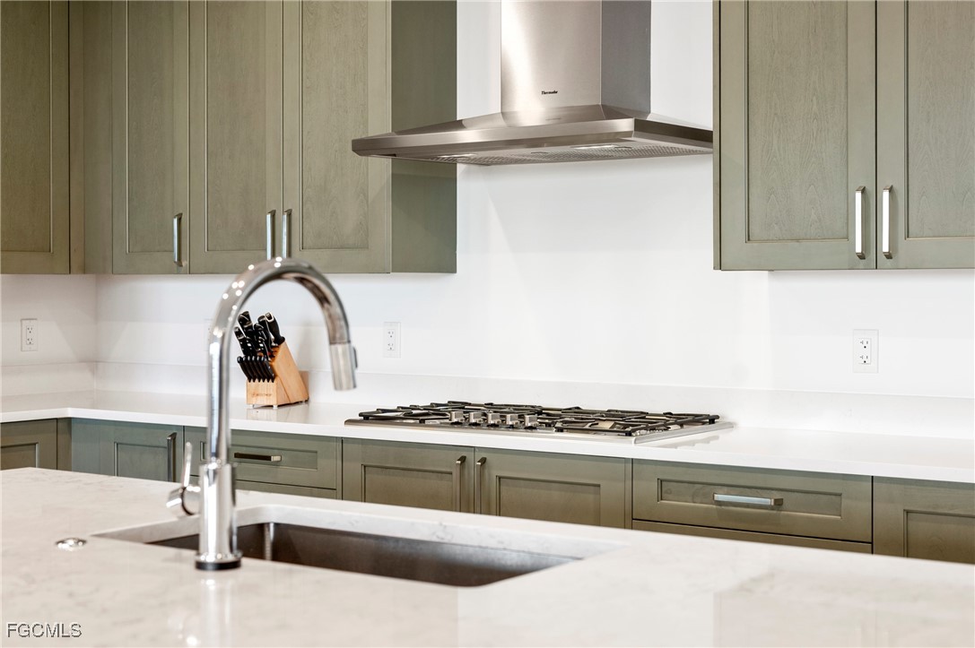 1125 Central Avenue, Unit 463 Naples, FL 34102 - Photo 9 of 42 a kitchen with granite countertop a stove and a sink