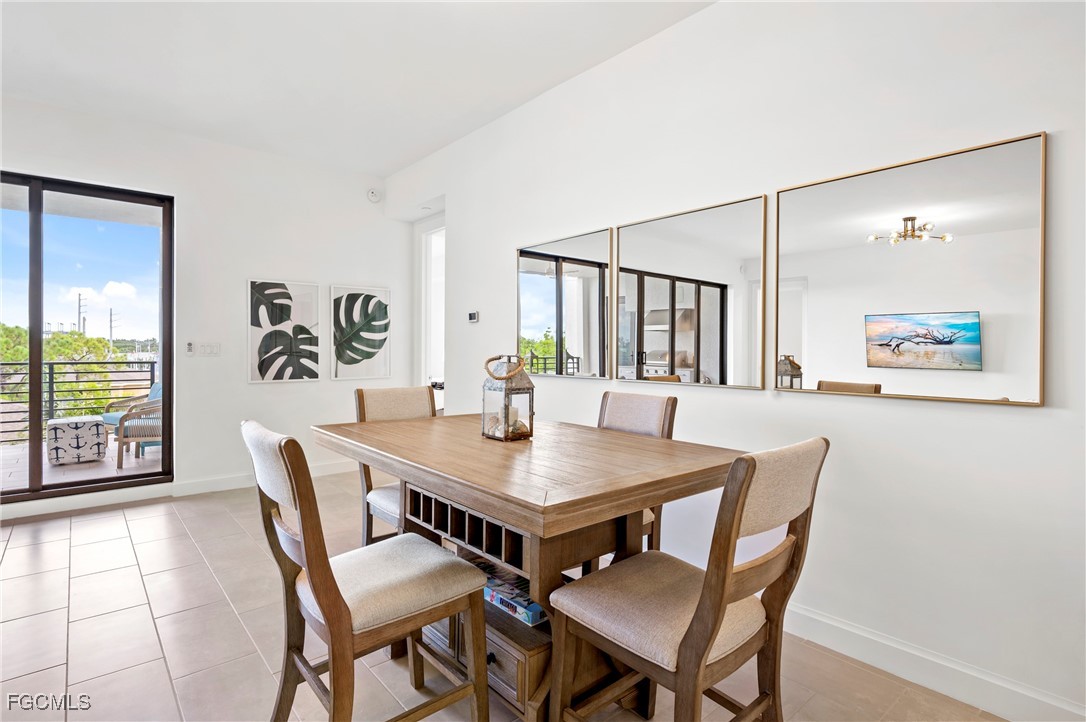 1125 Central Avenue, Unit 463 Naples, FL 34102 - Photo 10 of 42 a view of a dining room with furniture and a potted plant