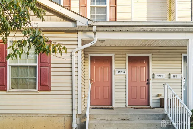 a view of a house with a window and wooden door