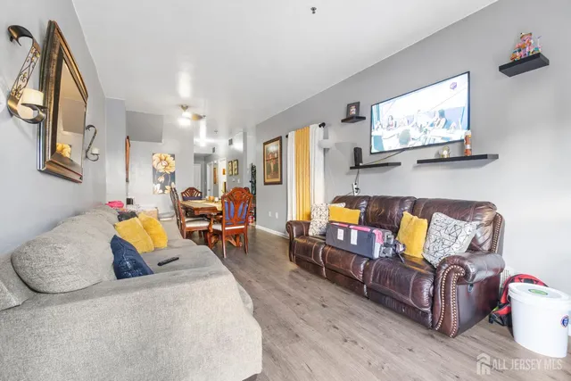 a living room with furniture and wooden floor