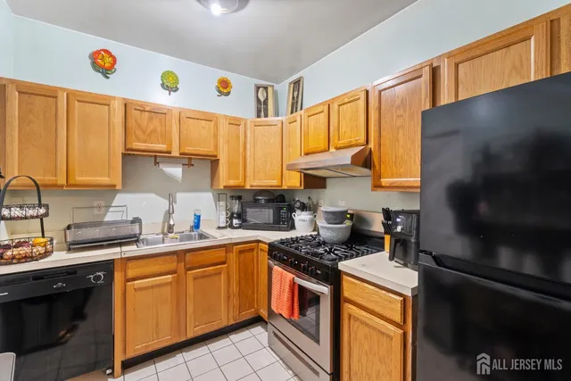 a kitchen with a sink a stove and cabinets