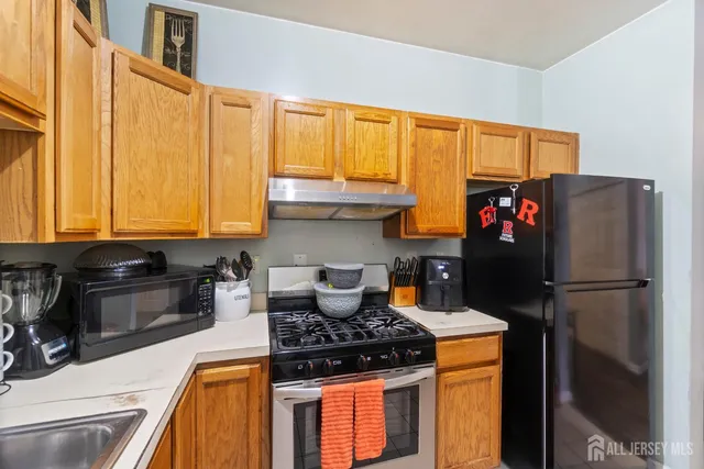 a kitchen with refrigerator and cabinets