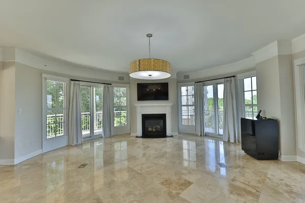 a view of a livingroom with an empty space and a fireplace
