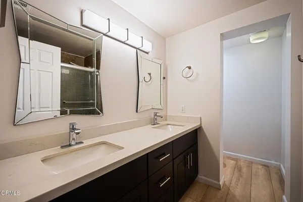a bathroom with a double vanity sink and mirror