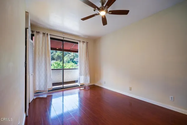 a view of empty room with wooden floor