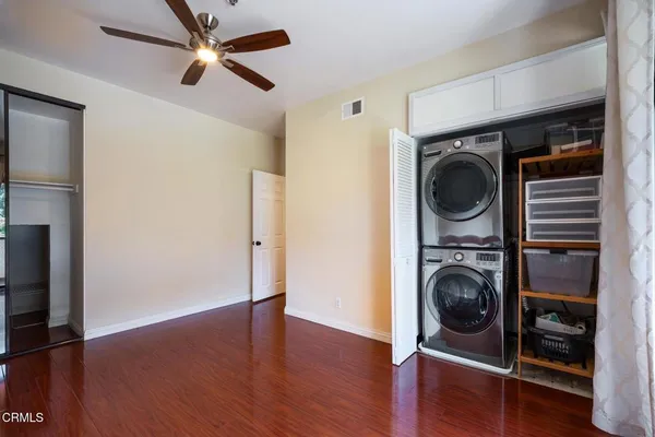 a view of a bedroom with washer and dryer