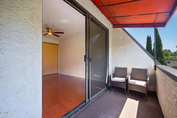 a view of a balcony with wooden floor