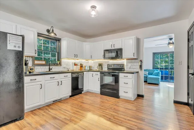 a kitchen with a stove a sink and a microwave
